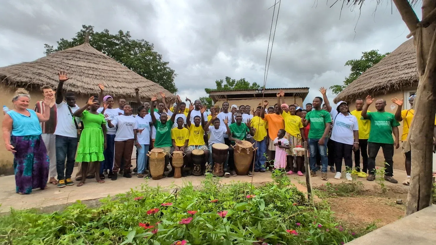A community gathering at Dream Village — visitors and residents around the drum circle
